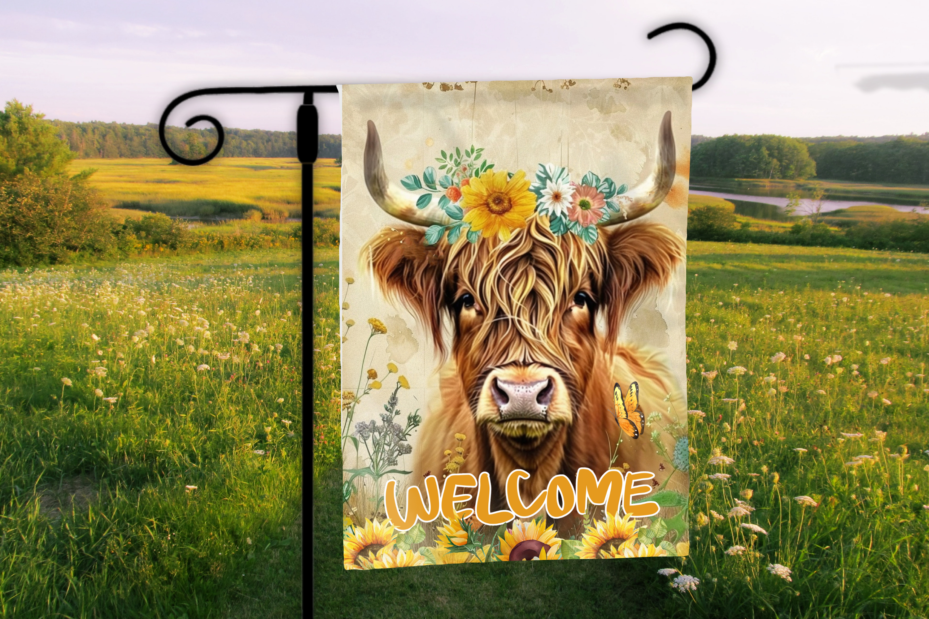 Decorative flag with a cow illustration and 'Welcome' text in a field setting