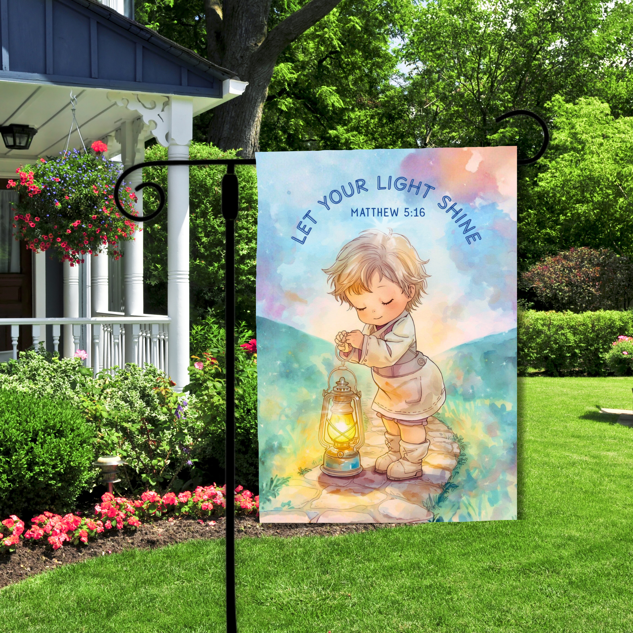 Decorative garden flag with a child holding a lantern and 'Let Your Light Shine' text, displayed outdoors.