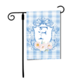 Decorative garden flag with floral design and letter 'F' on a blue plaid background, attached to a black flagpole.