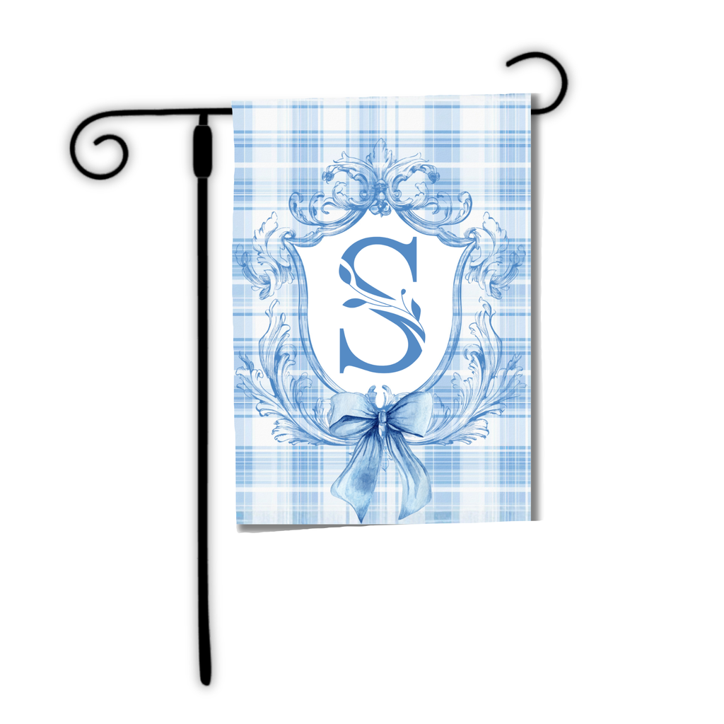 Decorative garden flag with blue monogram 'S' on a plaid background, attached to a black flagpole.