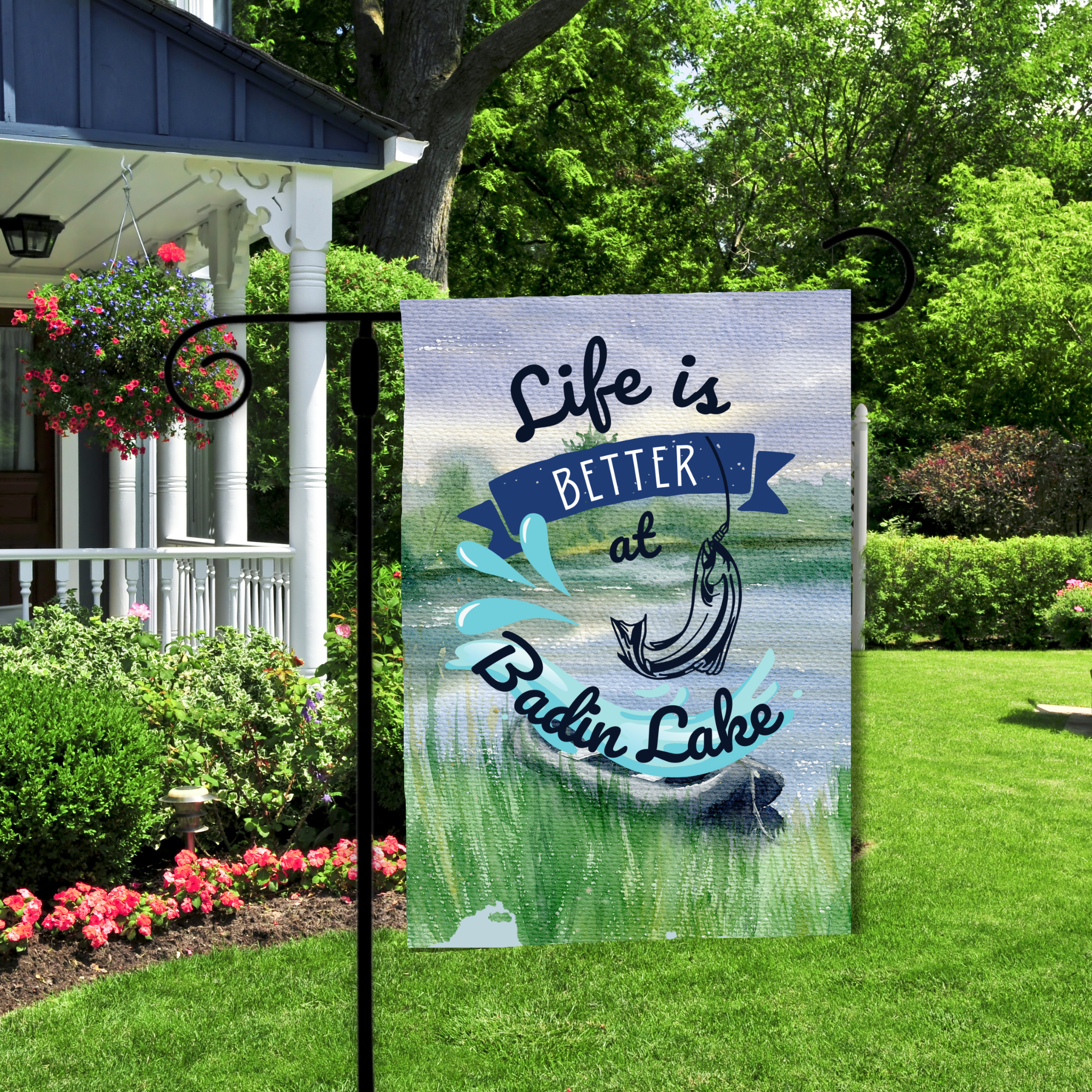 Garden flag with 'Life is Better at Badin Lake' text in a garden setting.