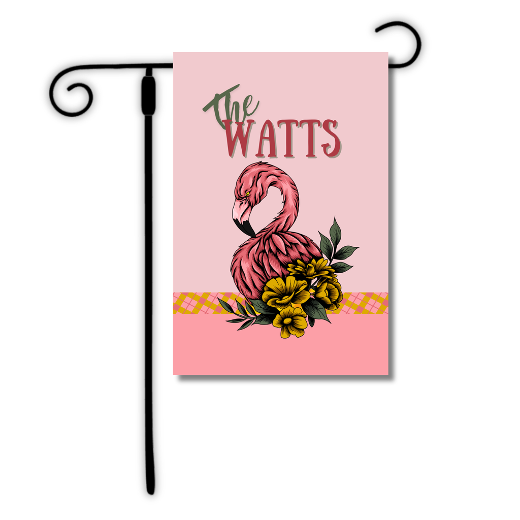 Decorative garden flag with pink flamingo design and 'The Watts' text on a pink background.